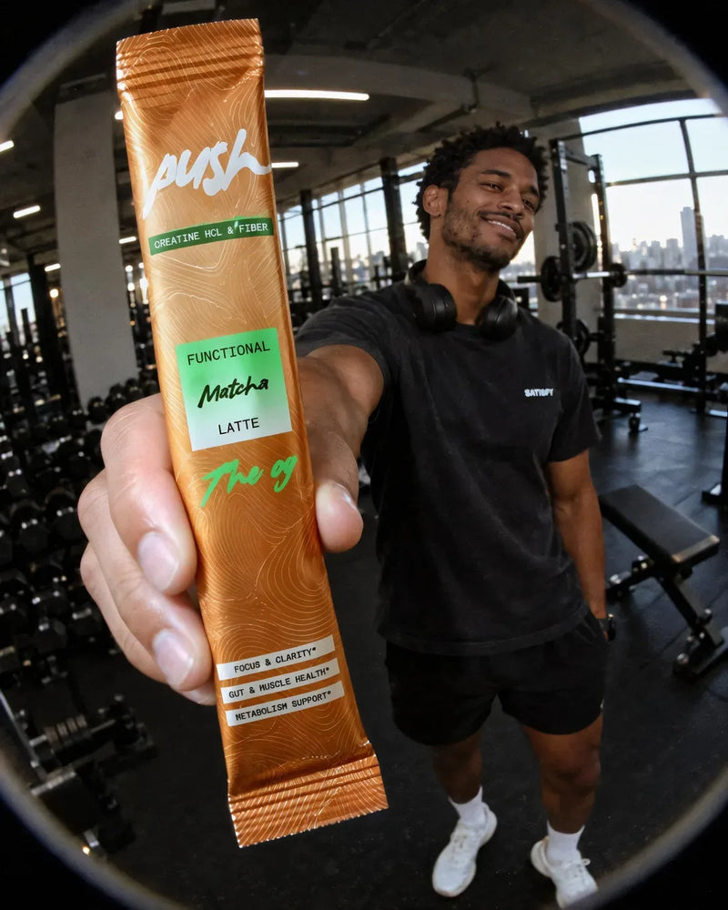 A man pushes a Push stick at the camera in a gym
